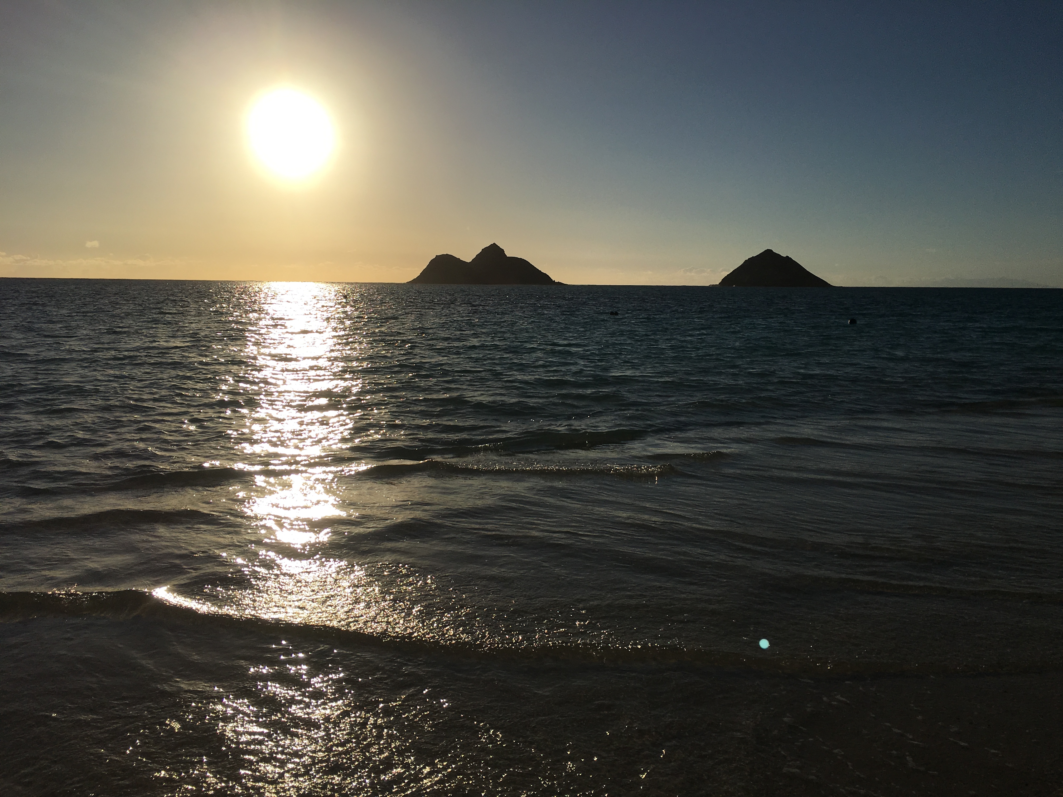Sunrise over Lanikai Beach with the Mokulua Islands silhouetted on the horizon, Oahu